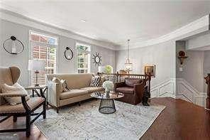 1667 Wehunt Pl SE Unit 11, Smyrna, GA 30082 - living area with crown molding, wood finished floors, and a decorative wall
