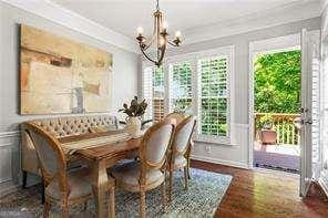 1667 Wehunt Pl SE Unit 11, Smyrna, GA 30082 - dining space featuring a chandelier, wood finished floors, and ornamental molding
