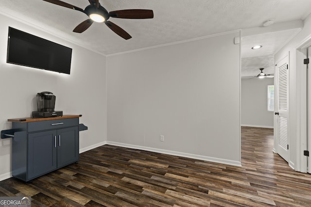 111 Northdale Pl, Lawrenceville, GA 30046 - unfurnished living room featuring a ceiling fan, dark wood-type flooring, ornamental molding, baseboards, and a textured ceiling