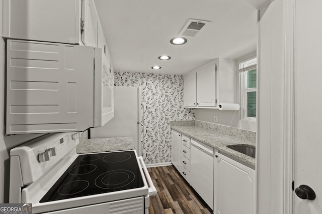 111 Northdale Pl, Lawrenceville, GA 30046 - kitchen with white appliances, white cabinetry, dark wood finished floors, wallpapered walls, and recessed lighting