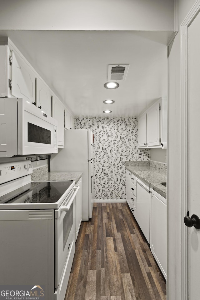 111 Northdale Pl, Lawrenceville, GA 30046 - kitchen with white appliances, wallpapered walls, white cabinetry, light countertops, and dark wood-style flooring
