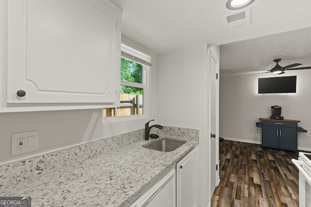 111 Northdale Pl, Lawrenceville, GA 30046 - kitchen with a sink, dark wood-type flooring, white cabinetry, light stone countertops, and a ceiling fan