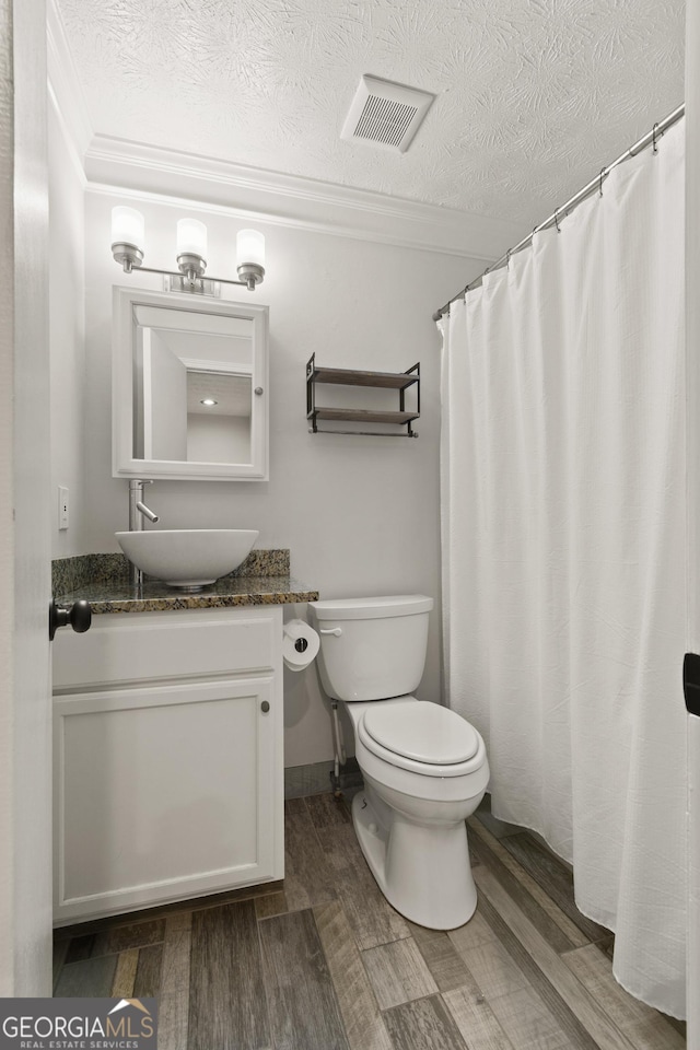 111 Northdale Pl, Lawrenceville, GA 30046 - bathroom featuring crown molding, toilet, vanity, wood finished floors, and a textured ceiling