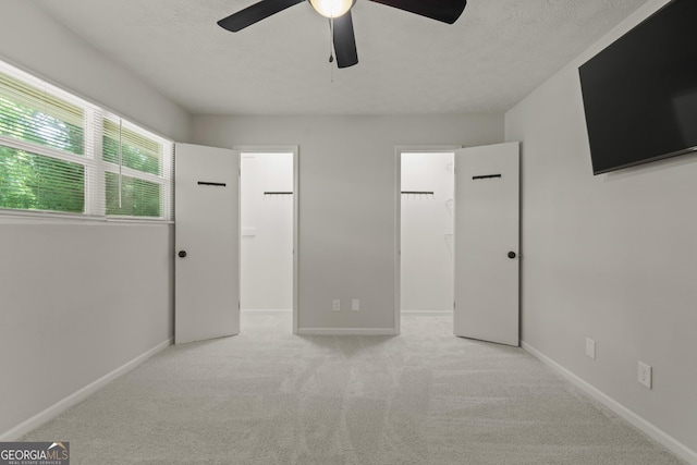 111 Northdale Pl, Lawrenceville, GA 30046 - unfurnished bedroom with a walk in closet, carpet floors, a closet, ceiling fan, and baseboards