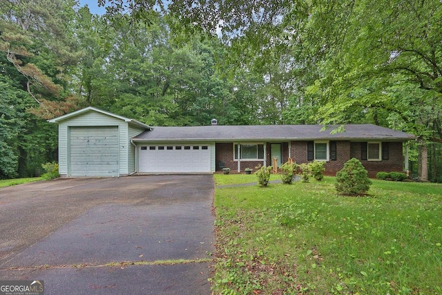 200 Dogwood Dr, Canton, GA 30114 - ranch-style house featuring driveway, an attached garage, a front lawn, and brick siding
