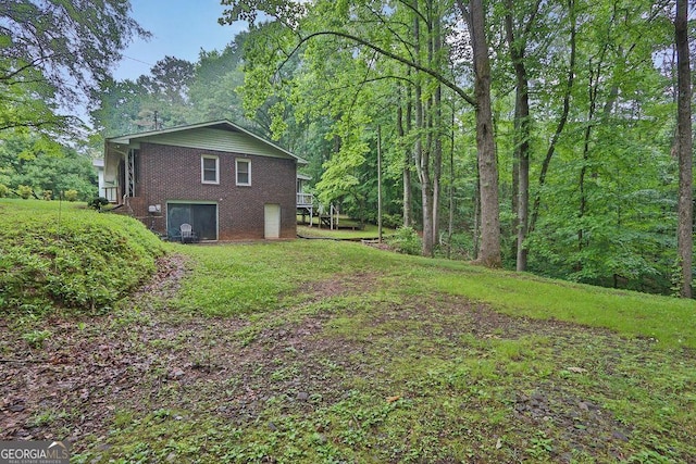 200 Dogwood Dr, Canton, GA 30114 - view of home's exterior with brick siding, a lawn, and a wooded view