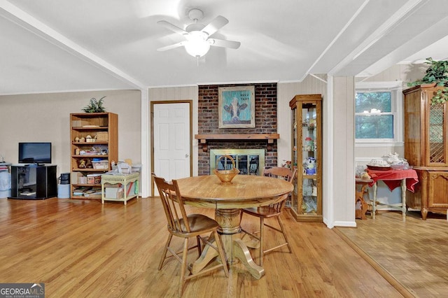 200 Dogwood Dr, Canton, GA 30114 - dining space with a fireplace, light wood-style floors, crown molding, and ceiling fan