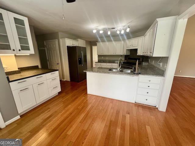 402 Hancock Ct, Woodstock, GA 30188 - kitchen featuring refrigerator with ice dispenser, gas range, light wood finished floors, and white cabinetry