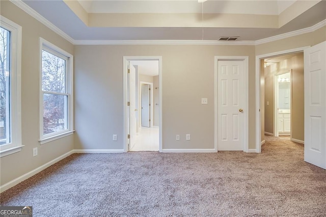 402 Hancock Ct, Woodstock, GA 30188 - unfurnished bedroom featuring carpet, a tray ceiling, crown molding, baseboards, and ensuite bath