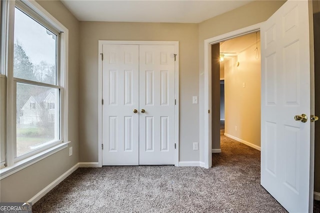 402 Hancock Ct, Woodstock, GA 30188 - unfurnished bedroom with carpet flooring, a closet, and baseboards