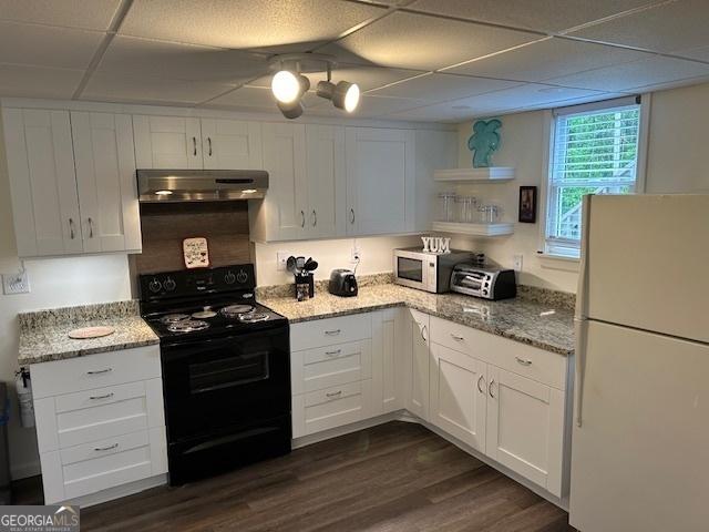 402 Hancock Ct, Woodstock, GA 30188 - kitchen with white appliances, under cabinet range hood, dark wood-style floors, white cabinets, and light stone counters