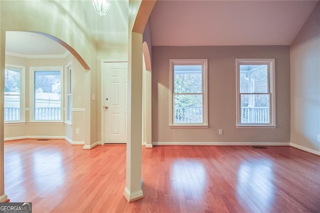402 Hancock Ct, Woodstock, GA 30188 - entryway featuring arched walkways, light wood-style floors, baseboards, crown molding, and vaulted ceiling