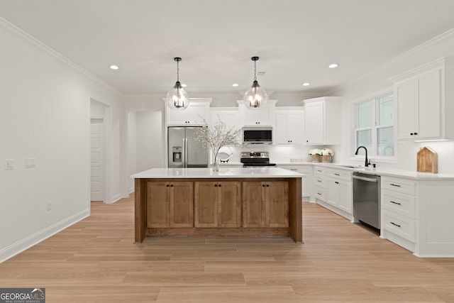 108 Branch Creek Rd, Woodbine, GA 31569 - kitchen featuring stainless steel appliances, crown molding, backsplash, white cabinets, and a sink