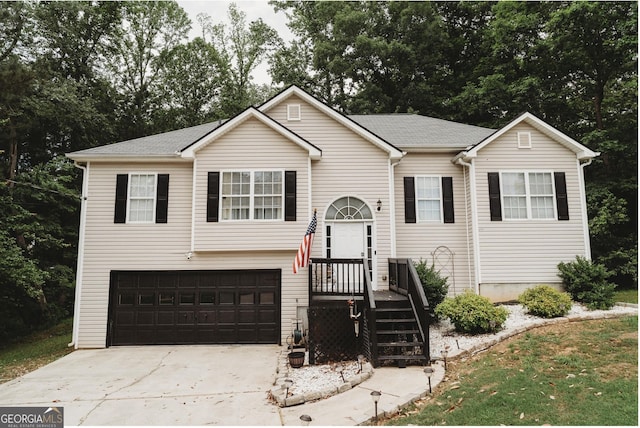 228 Hunt Club Cir, Temple, GA 30179 - bi-level home featuring concrete driveway, an attached garage, and view of scattered trees