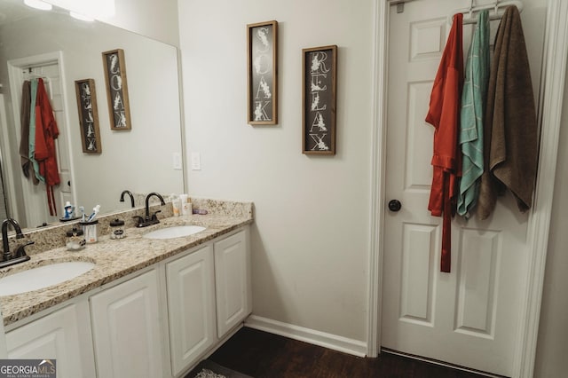 228 Hunt Club Cir, Temple, GA 30179 - full bathroom with baseboards, double vanity, and wood finished floors