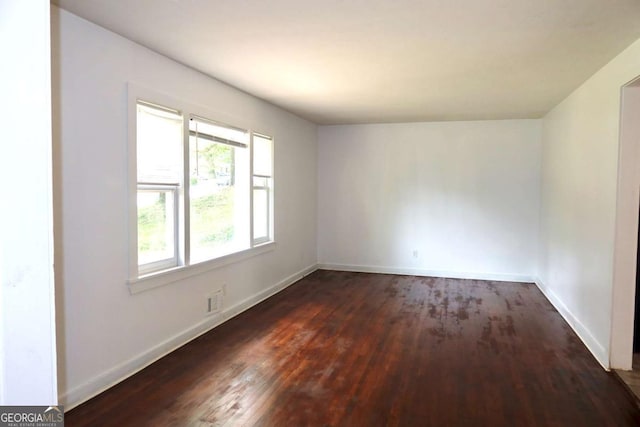 579 Kenridge Cir, Stone Mountain, GA 30083 - spare room with dark wood finished floors and baseboards