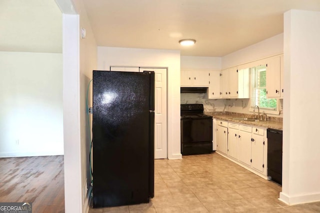 579 Kenridge Cir, Stone Mountain, GA 30083 - kitchen with black appliances, a sink, baseboards, and white cabinetry