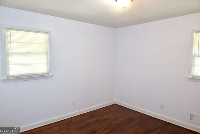 579 Kenridge Cir, Stone Mountain, GA 30083 - unfurnished room with baseboards, dark wood finished floors, and plenty of natural light