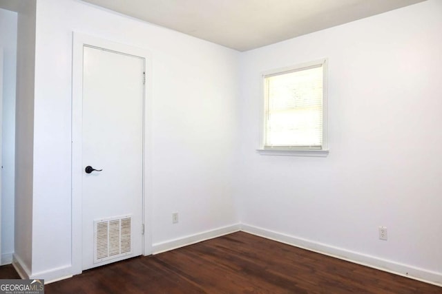 579 Kenridge Cir, Stone Mountain, GA 30083 - unfurnished bedroom with dark wood-style floors and baseboards