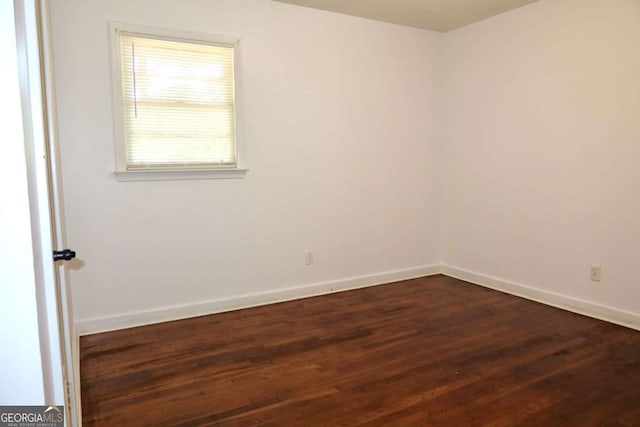 579 Kenridge Cir, Stone Mountain, GA 30083 - spare room with dark wood finished floors and baseboards