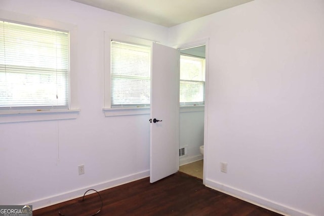 579 Kenridge Cir, Stone Mountain, GA 30083 - spare room with dark wood-style floors and baseboards