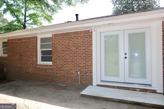 579 Kenridge Cir, Stone Mountain, GA 30083 - view of exterior entry featuring french doors, brick siding, and a patio