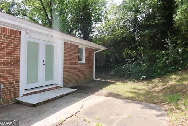 579 Kenridge Cir, Stone Mountain, GA 30083 - view of exterior entry with brick siding, french doors, and a patio area