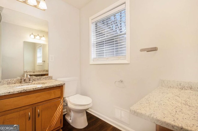 1602 Sycamore Dr NW, Kennesaw, GA 30152 - bathroom with wood finished floors, baseboards, toilet, and vanity