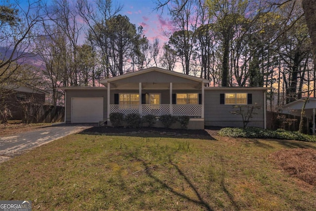 1602 Sycamore Dr NW, Kennesaw, GA 30152 - view of front of home with a garage, a porch, concrete driveway, and a lawn