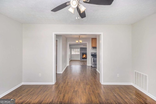 1602 Sycamore Dr NW, Kennesaw, GA 30152 - spare room featuring dark wood-style floors, a textured ceiling, baseboards, and a ceiling fan