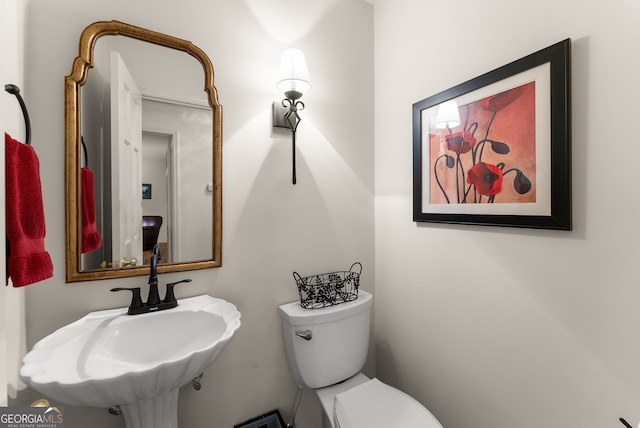 half bath with a sink and toilet