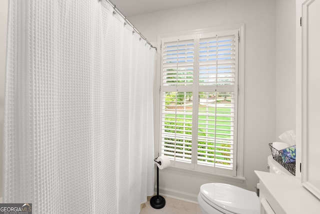 full bathroom with toilet, vanity, and tile patterned floors