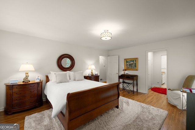 bedroom with wood finished floors and baseboards