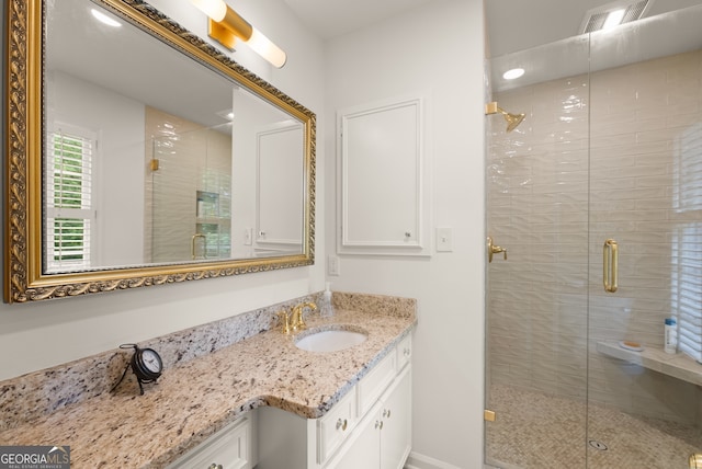 full bath with vanity and a shower stall