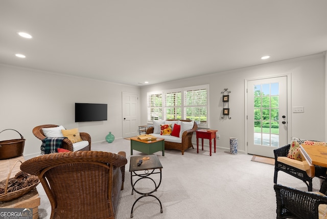living room with crown molding, recessed lighting, plenty of natural light, baseboards, and light carpet