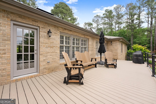 wooden deck featuring a grill