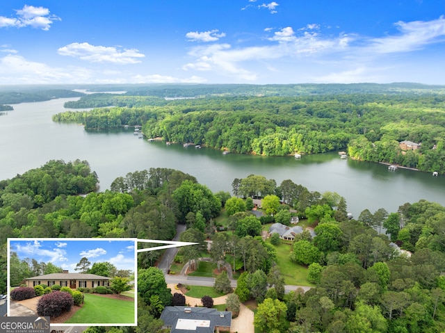 aerial view of property and surrounding area featuring a large body of water, a forest, and property boundaries highlighted