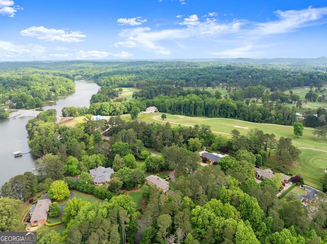 aerial view of a nearby body of water, a forest, and a local golf course