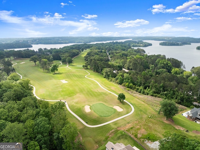 drone / aerial view of a nearby body of water and a golf course