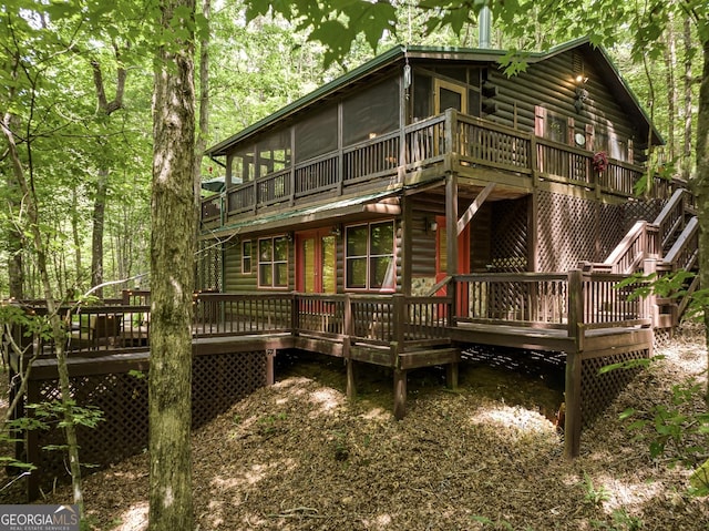 122 River Bend Trl, Ellijay, GA 30540 - back of property with a wooden deck, faux log siding, and a sunroom