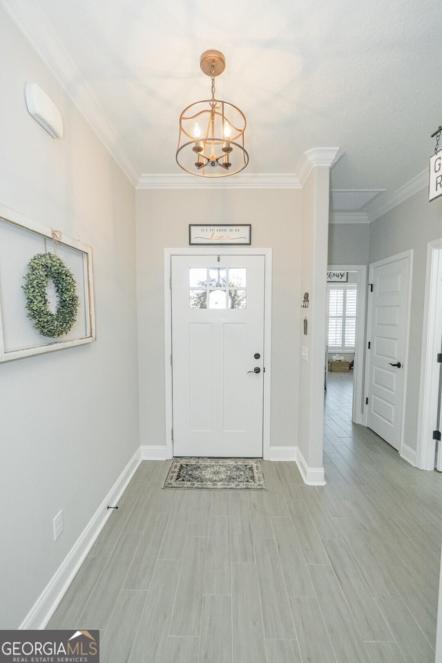 133 Ryan Nicholas Dr, Kingsland, GA 31548 - entryway with a chandelier, crown molding, baseboards, and light wood-type flooring