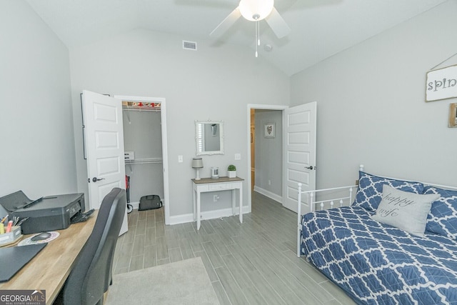 133 Ryan Nicholas Dr, Kingsland, GA 31548 - bedroom featuring a walk in closet, wood finish floors, a desk, a ceiling fan, and high vaulted ceiling