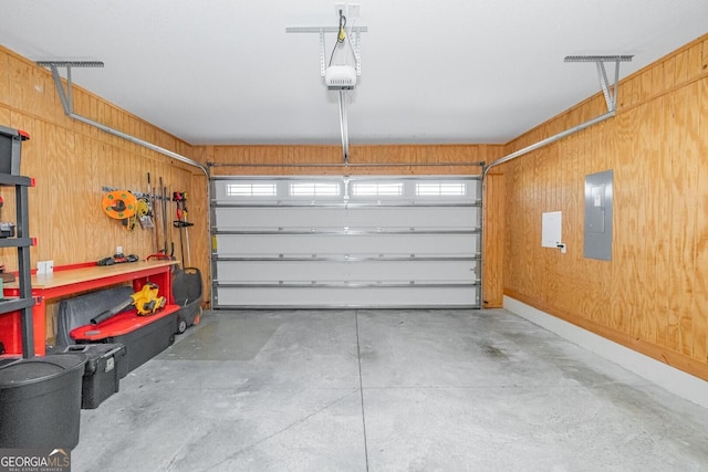 133 Ryan Nicholas Dr, Kingsland, GA 31548 - garage featuring electric panel, a garage door opener, and wooden walls