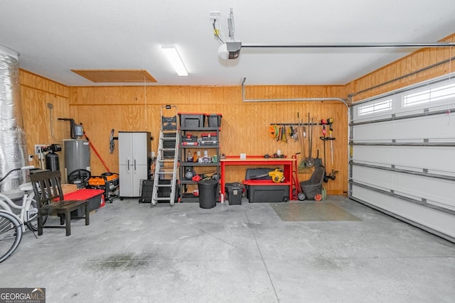 133 Ryan Nicholas Dr, Kingsland, GA 31548 - garage with a garage door opener, gas water heater, and wooden walls