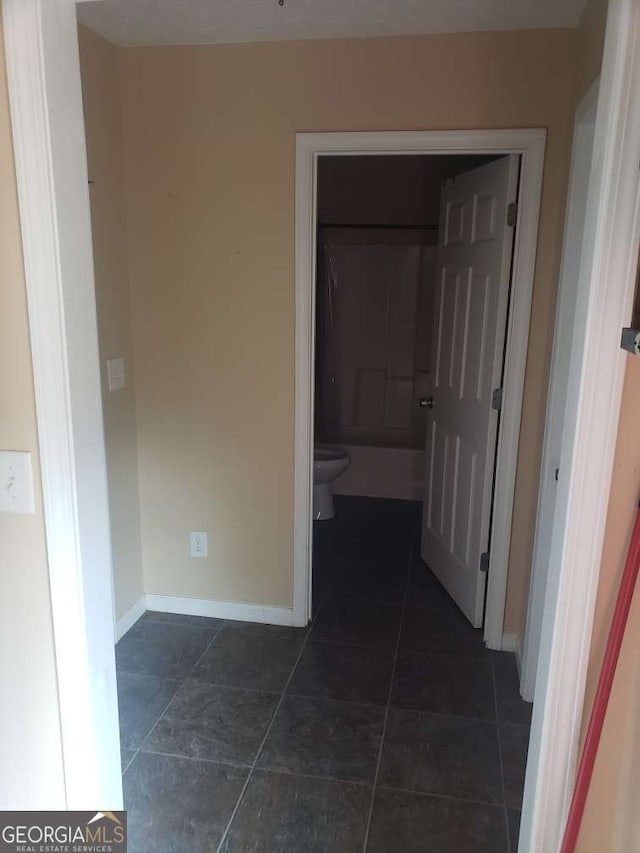 1383 Sims Rd SE, Winder, GA 30680 - hall featuring baseboards and dark tile patterned flooring