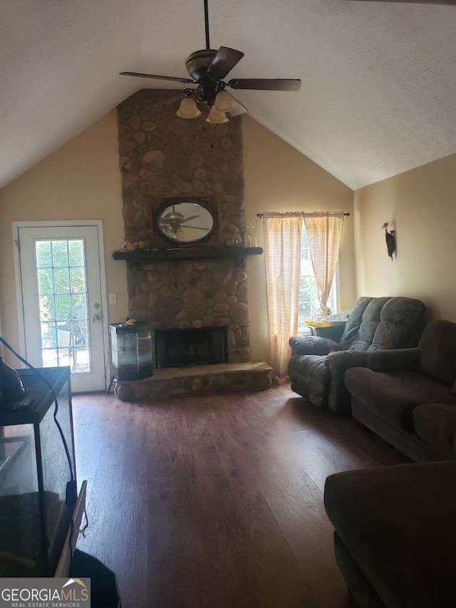 1383 Sims Rd SE, Winder, GA 30680 - living area with a ceiling fan, vaulted ceiling, wood finished floors, and a stone fireplace