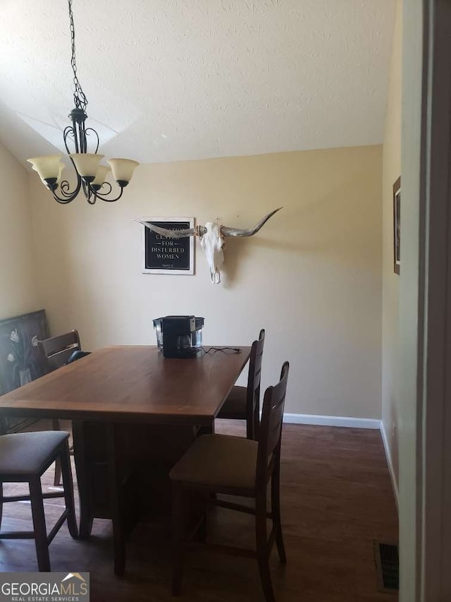 1383 Sims Rd SE, Winder, GA 30680 - dining room featuring a textured ceiling, a chandelier, wood finished floors, and baseboards