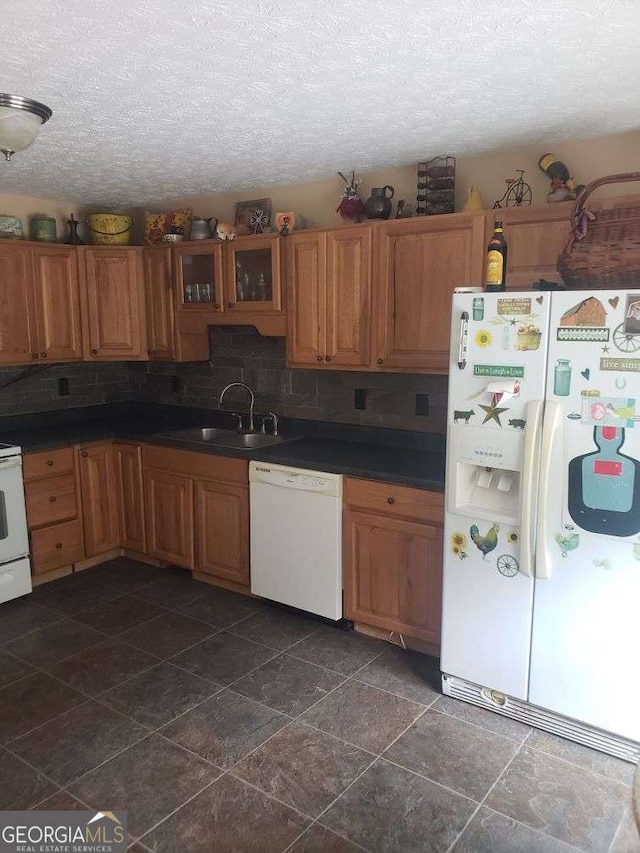1383 Sims Rd SE, Winder, GA 30680 - kitchen featuring white appliances, a sink, a textured ceiling, tasteful backsplash, and dark countertops