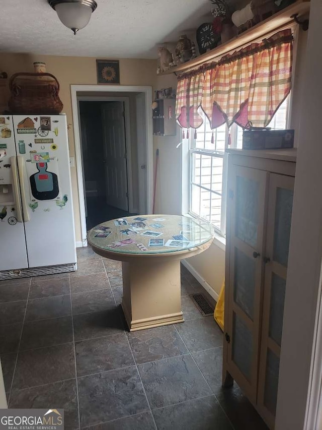 1383 Sims Rd SE, Winder, GA 30680 - dining space with a textured ceiling and dark stone finish flooring