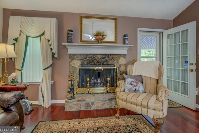 3870 Michaels Creek Ct, Loganville, GA 30052 - living area featuring wood finished floors, baseboards, and a stone fireplace